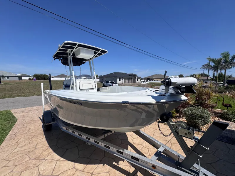 Slide: The Image of 2021 Clearwater 2000 C/C boat on trailer under cloudy sky at dealership. - 8