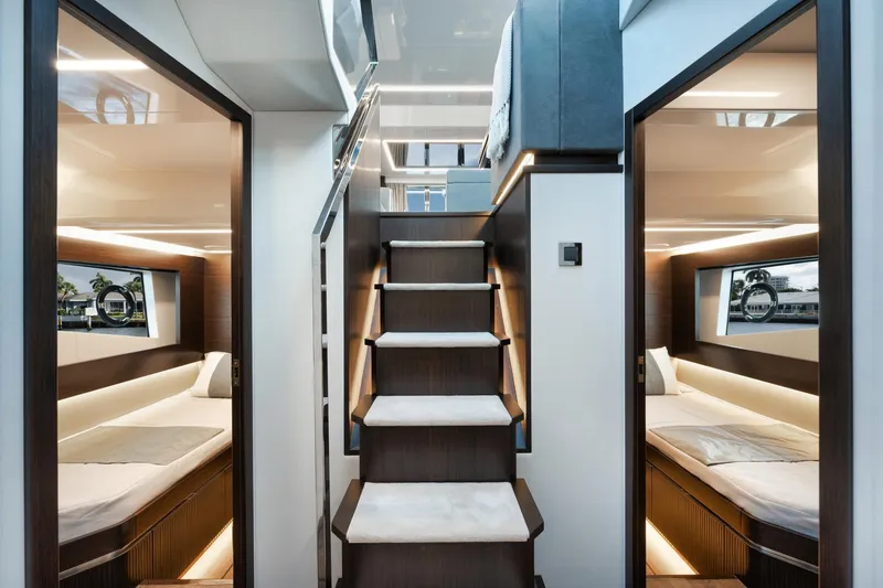 Slide: The Image of Luxurious interior of 2022 Pearl 62 yacht with modern twin cabins and elegant staircase. - 12