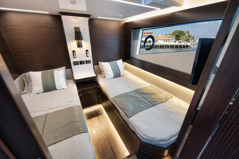 Slide: The Image of Luxurious twin cabin interior of 2022 Pearl 62 yacht with modern design and scenic window view. - 15