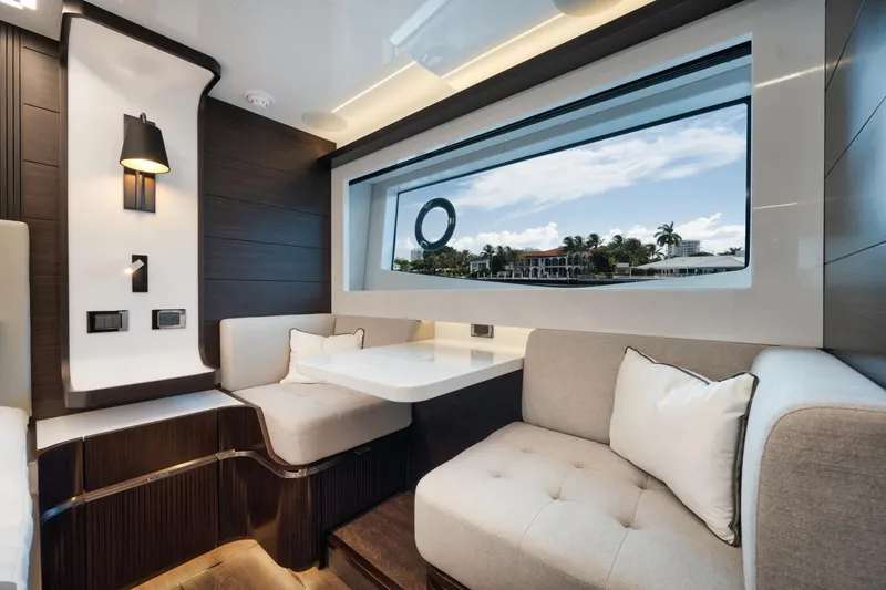 Slide: The Image of Luxurious interior of 2022 Pearl 62 yacht with elegant seating and large window view. - 23
