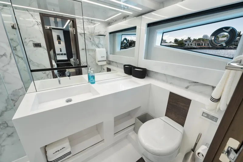 Slide: The Image of Luxurious bathroom on 2022 Pearl 62 yacht with modern fixtures and scenic window view. - 25