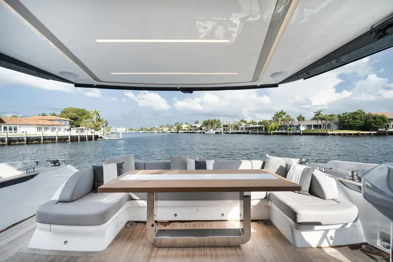 Slide: The Image of Luxurious Pearl 62 yacht deck with elegant seating and scenic waterfront view, 2022 model. - 26