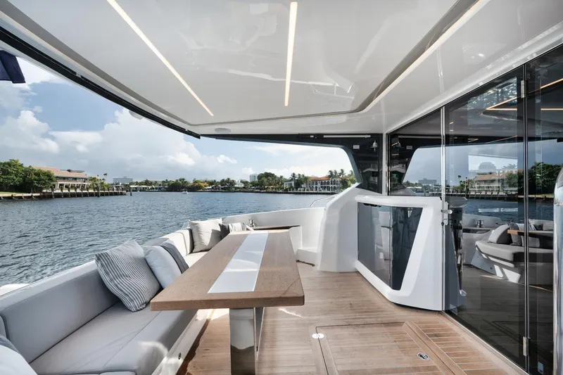 Slide: The Image of Luxurious Pearl 62 yacht deck, 2022 model, featuring elegant seating and scenic waterfront view. - 27
