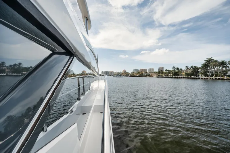 Slide: The Image of Pearl 62 yacht cruising on a scenic waterway, 2022 model. - 28