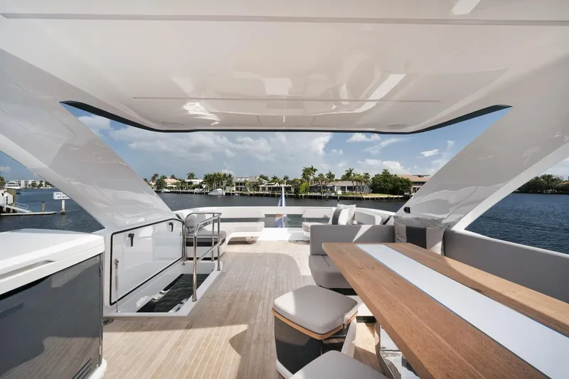 Slide: The Image of Luxurious Pearl 62 yacht deck, 2022 model, featuring elegant seating and scenic waterfront views. - 35