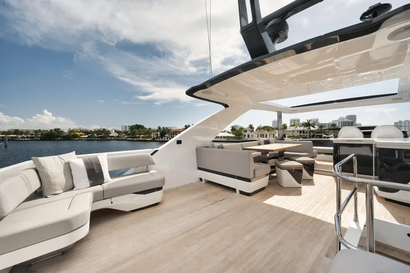 Slide: The Image of Luxurious 2022 Pearl 62 yacht deck with modern seating and scenic waterfront view. - 36
