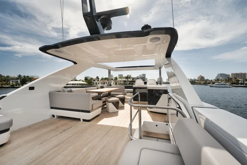Slide: The Image of Luxurious 2022 Pearl 62 yacht deck with modern seating and scenic waterfront view. - 37