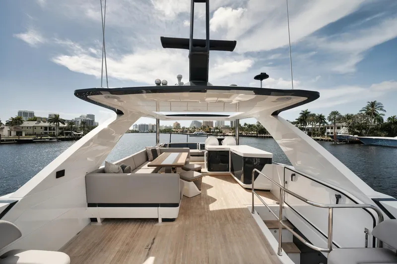 Slide: The Image of Luxurious 2022 Pearl 62 yacht deck with seating, table, and scenic waterfront view. - 38