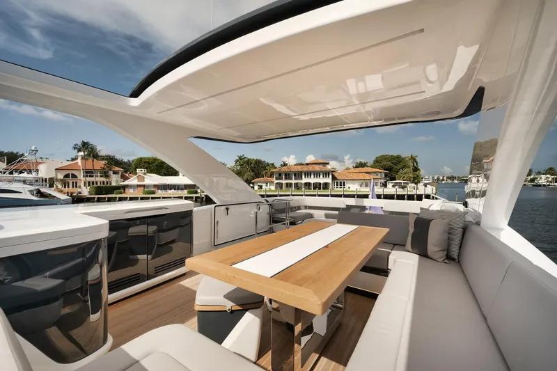 Slide: The Image of Luxurious 2022 Pearl 62 yacht deck with elegant seating and dining area. - 39