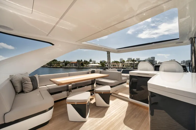 Slide: The Image of Luxurious 2022 Pearl 62 yacht interior with modern seating and scenic waterfront view. - 42