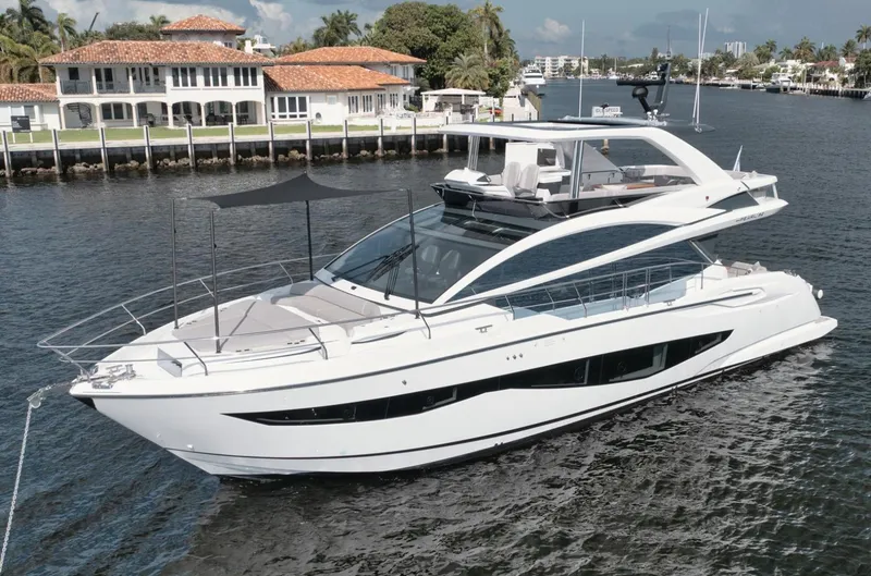 Slide: The Image of Luxurious 2022 Pearl 62 yacht cruising near waterfront homes. - 46