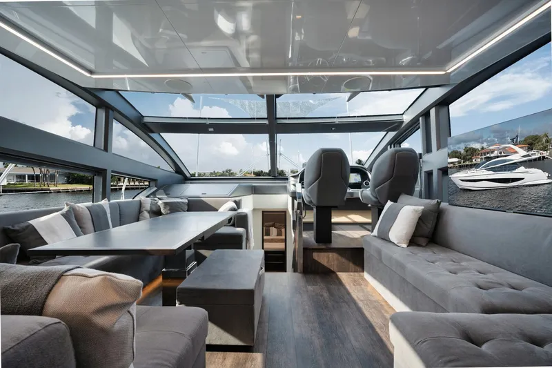 Slide: The Image of Luxurious interior of 2022 Pearl 62 yacht with modern seating and panoramic windows. - 7