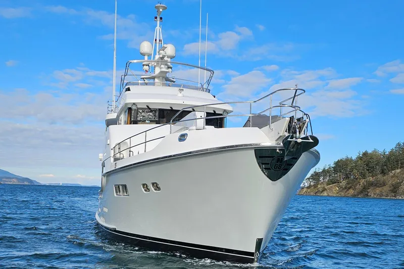 Slide: The Image of Nordhavn 68 yacht from 2009 on open water, clear sky background. - 4