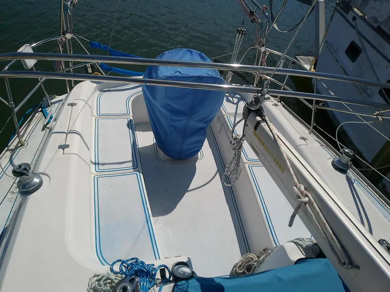 Slide: The Image of Bavaria 37 Cruiser 2001 sailboat deck with blue cover and ropes. - 13