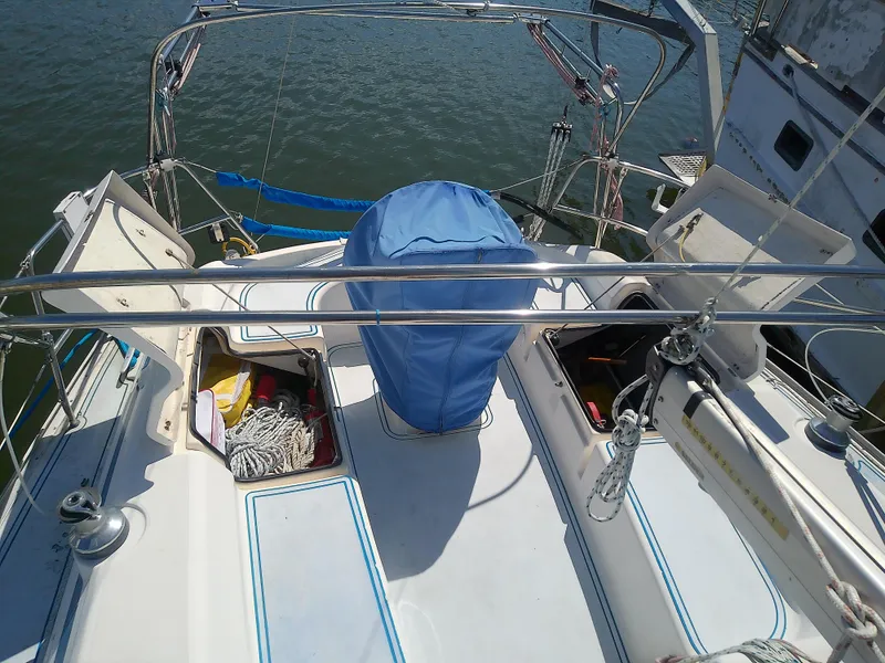 Slide: The Image of Bavaria 37 Cruiser 2001 sailboat deck with open storage compartments and blue cover. - 14