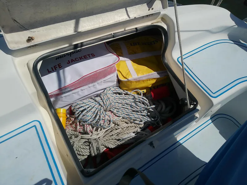 Slide: The Image of Storage compartment on 2001 Bavaria 37 Cruiser with life jackets and ropes. - 15