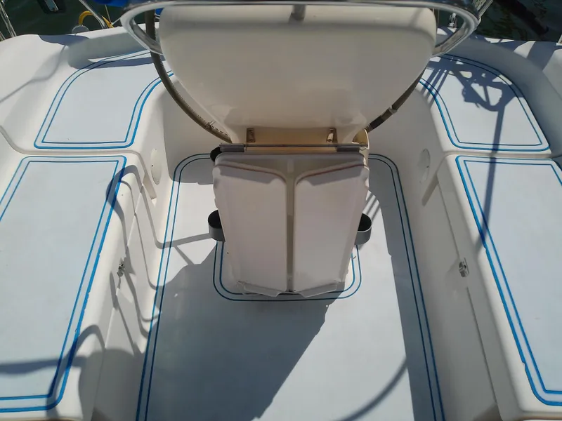 Slide: The Image of Cockpit of 2001 Bavaria 37 Cruiser sailboat with white seating and blue trim. - 17