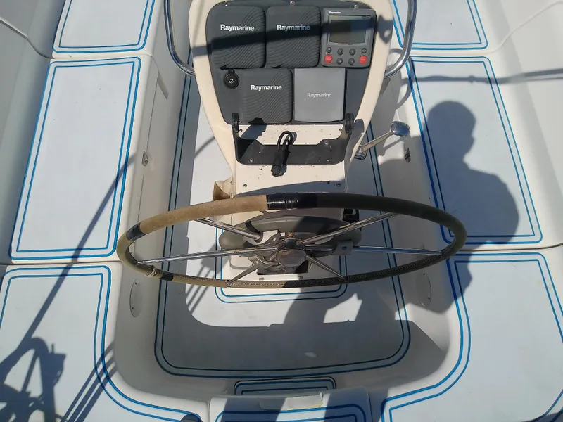 Slide: The Image of Steering wheel and controls of a 2001 Bavaria 37 Cruiser sailboat. - 19
