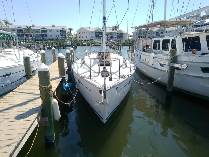 Slide: The Image of Bavaria 37 Cruiser 2001 docked at marina, surrounded by other boats. - 2
