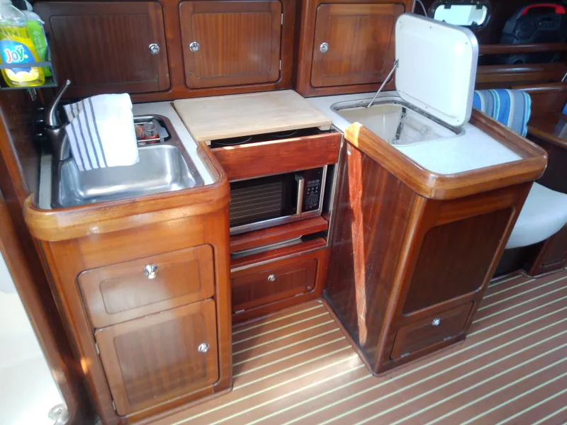 Slide: The Image of Interior of 2001 Bavaria 37 Cruiser yacht kitchen with wooden cabinets and appliances. - 24