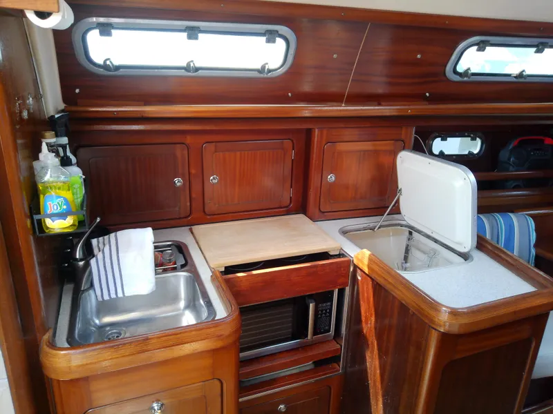 Slide: The Image of Interior of 2001 Bavaria 37 Cruiser yacht kitchen with wooden cabinets and sink. - 25