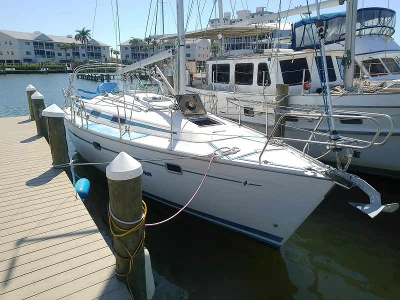 Slide: The Image of Bavaria 37 Cruiser 2001 docked at marina, surrounded by other boats. - 3