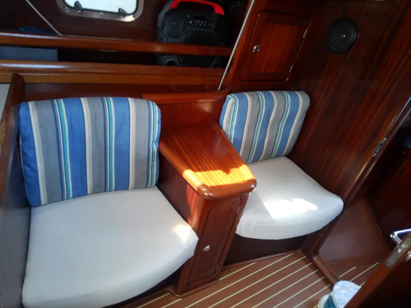 Slide: The Image of Interior of 2001 Bavaria 37 Cruiser with striped cushions and wooden finish. - 31