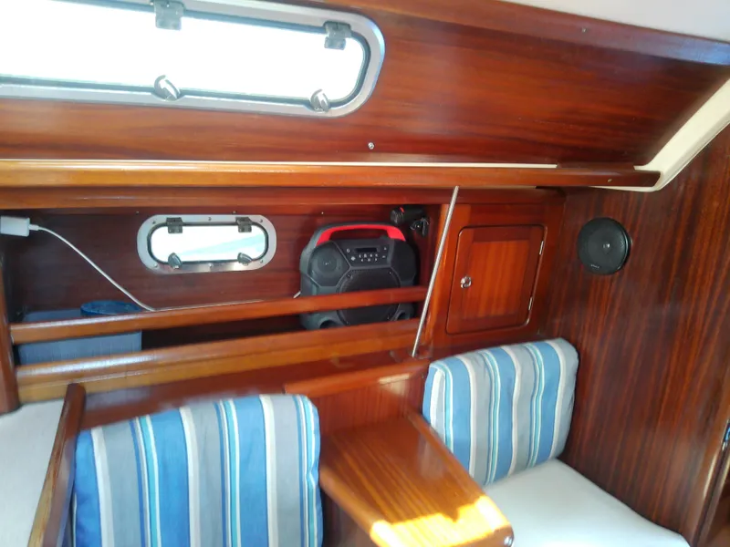 Slide: The Image of Interior of 2001 Bavaria 37 Cruiser with wooden finish and striped seating. - 32