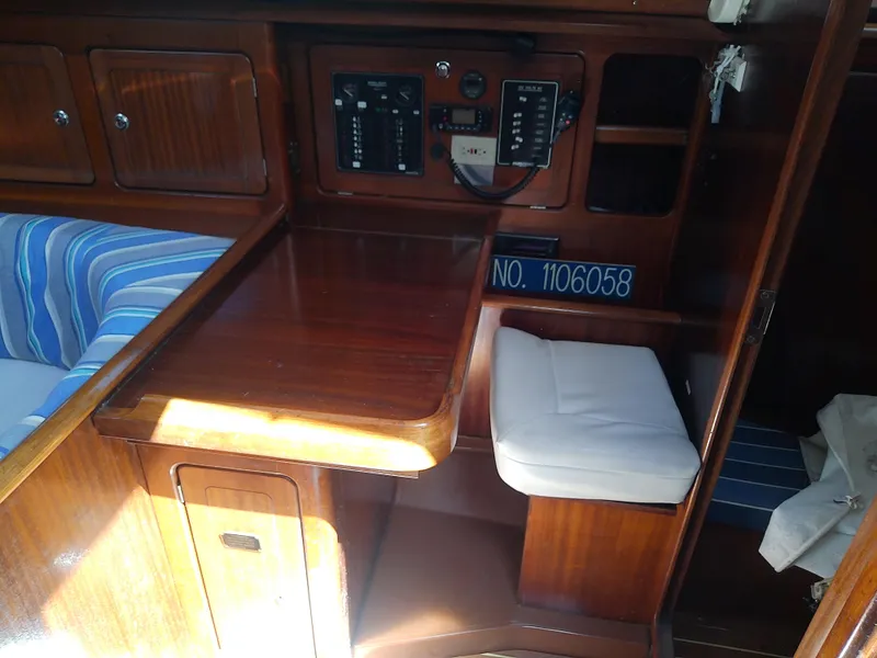 Slide: The Image of Interior of 2001 Bavaria 37 Cruiser yacht with wooden cabinetry and navigation station. - 34