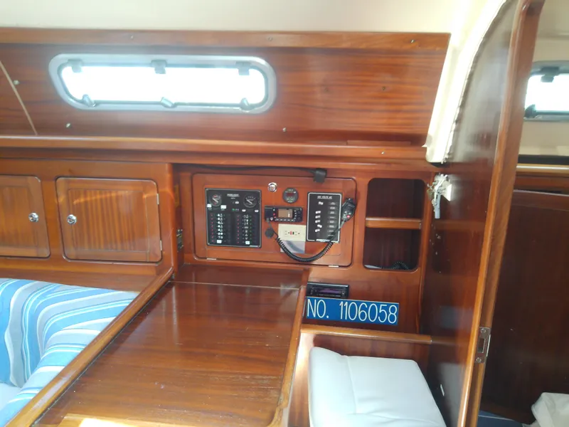 Slide: The Image of Interior of 2001 Bavaria 37 Cruiser yacht with wooden cabinetry and control panel. - 35