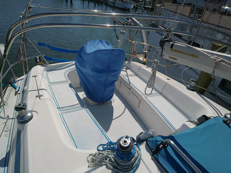 Slide: The Image of Bavaria 37 Cruiser 2001 yacht deck with blue covers and ropes in marina. - 4