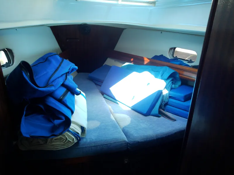 Slide: The Image of Interior cabin of 2001 Bavaria 37 Cruiser with blue cushions and bags. - 41