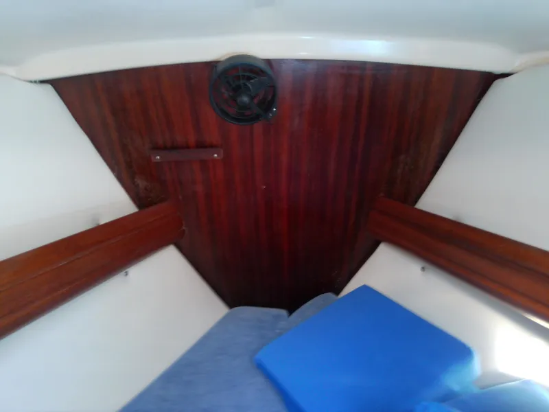 Slide: The Image of Interior cabin of 2001 Bavaria 37 Cruiser with wooden paneling and blue cushions. - 46