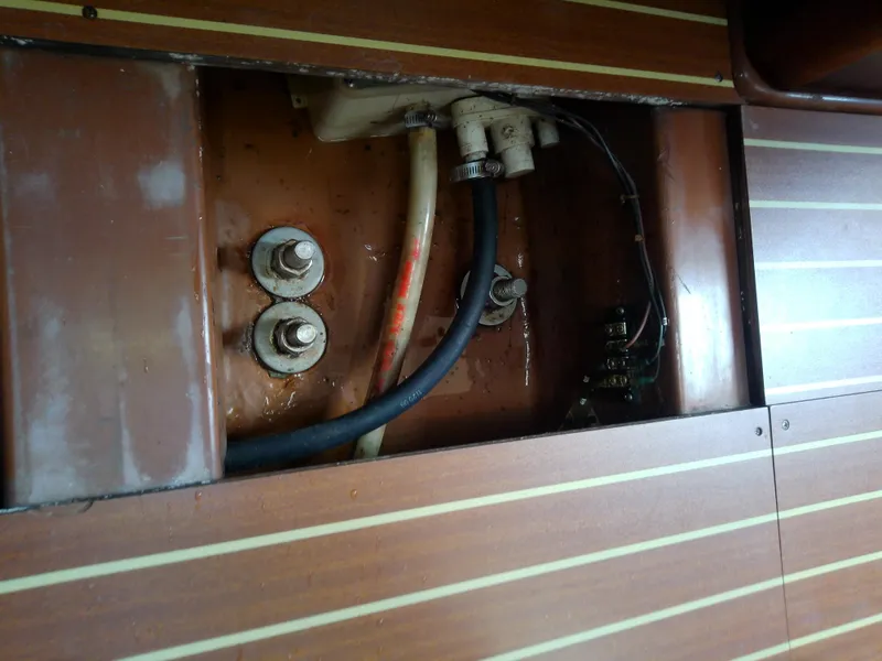 Slide: The Image of Interior view of Bavaria 37 Cruiser 2001, showing wiring and fittings behind wooden panel. - 48