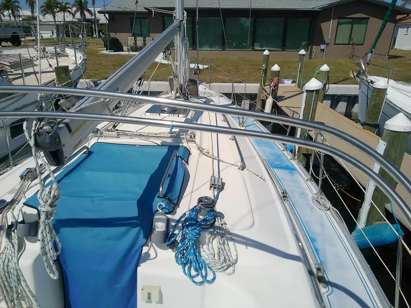 Slide: The Image of Bavaria 37 Cruiser 2001 sailboat deck with blue cover and ropes at marina. - 6