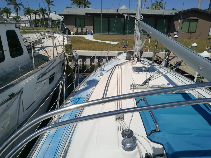 Slide: The Image of Bavaria 37 Cruiser 2001 sailboat docked near waterfront homes. - 7