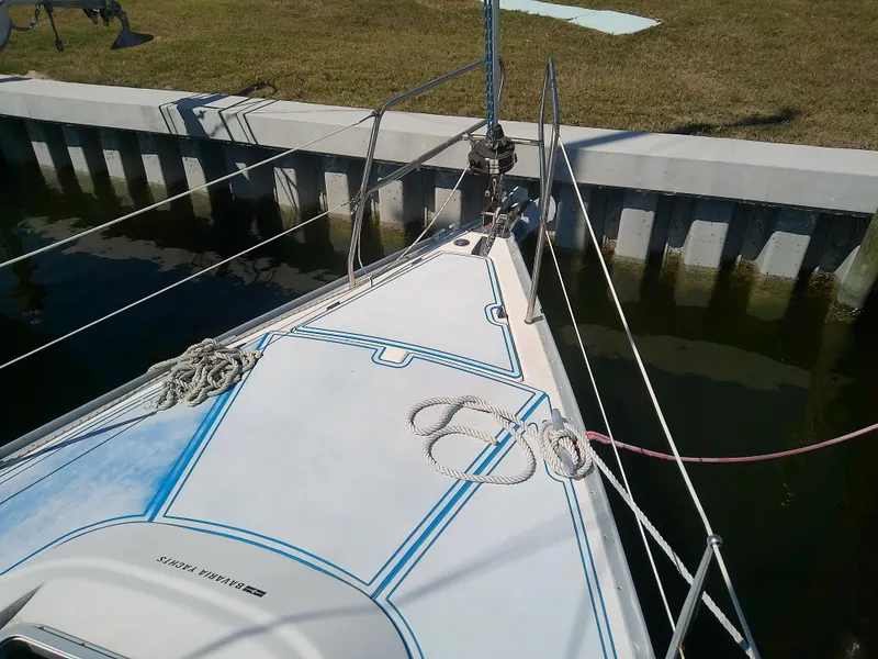 Slide: The Image of Bavaria 37 Cruiser 2001 sailboat docked, showing deck and mooring ropes. - 8