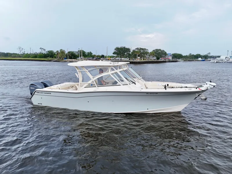 Slide: The Image of 2022 Grady-White Freedom 307 boat on calm water, side view. - 12