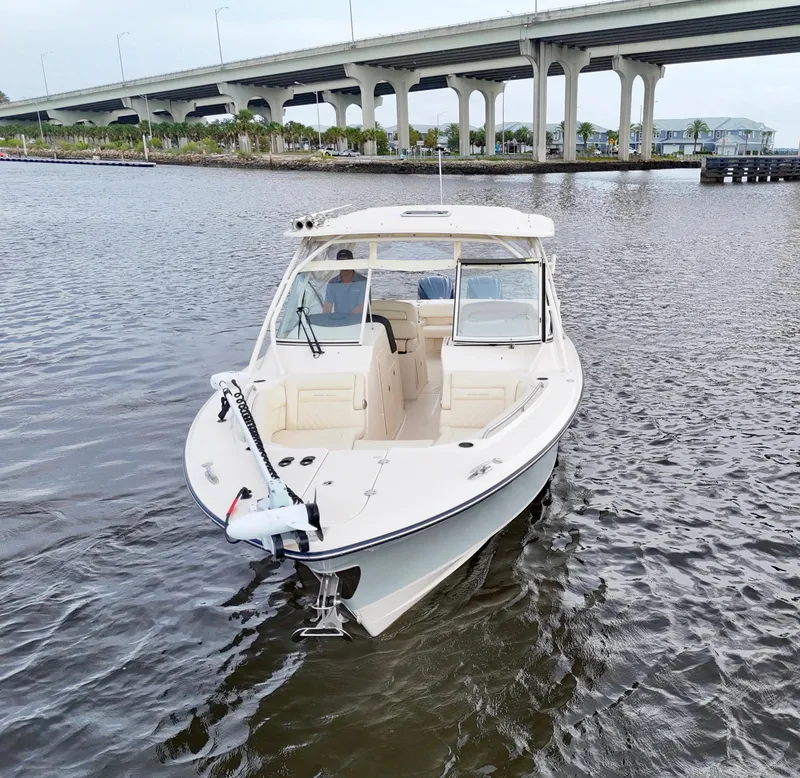 Slide: The Image of 2022 Grady-White Freedom 307 boat on water near a bridge. - 15
