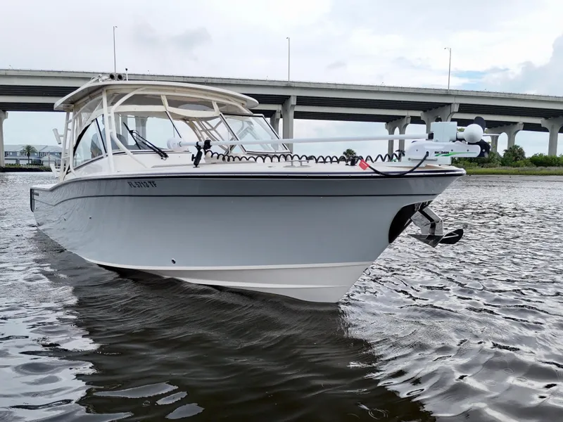 Slide: The Image of 2022 Grady-White Freedom 307 boat on water near a bridge. - 19