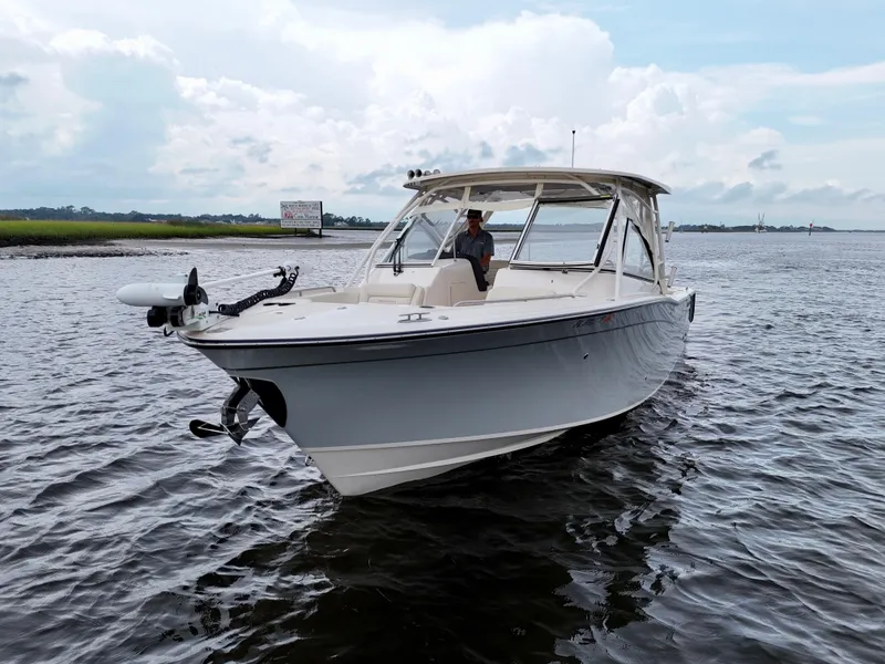 Slide: The Image of 2022 Grady-White Freedom 307 boat on calm water under cloudy sky. - 22