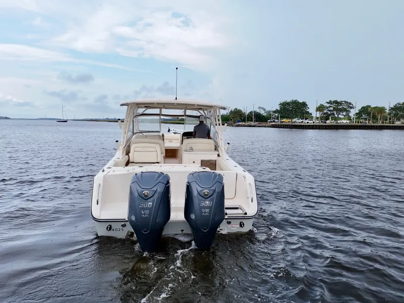 Slide: The Image of 2022 Grady-White Freedom 307 boat on water, rear view with dual engines. - 24