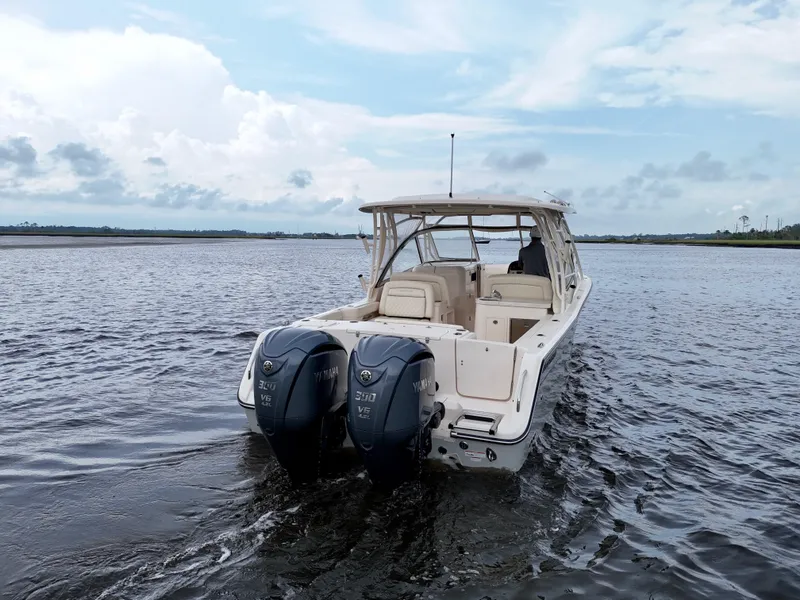 Slide: The Image of 2022 Grady-White Freedom 307 boat with twin Yamaha engines on open water. - 25