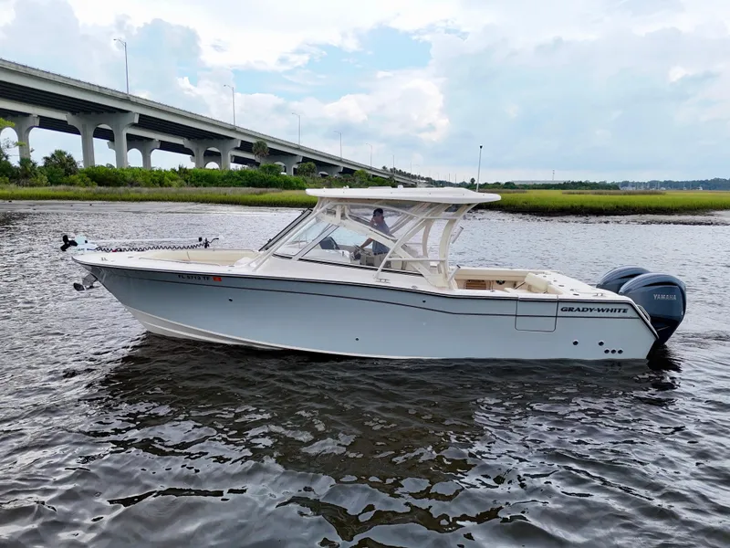Slide: The Image of 2022 Grady-White Freedom 307 boat on water near a bridge, side view. - 26