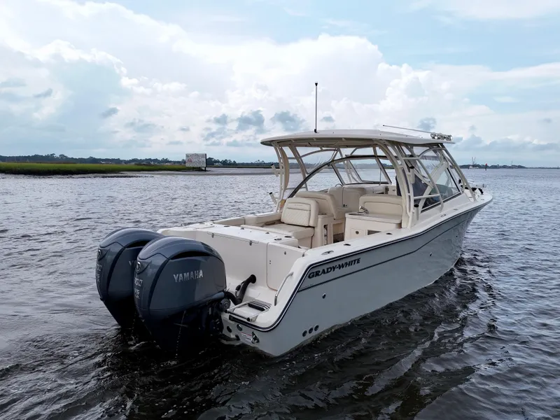 Slide: The Image of 2022 Grady-White Freedom 307 boat with Yamaha engines on calm water. - 30