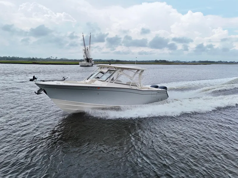 Slide: The Image of 2022 Grady-White Freedom 307 boat cruising on a calm waterway. - 4