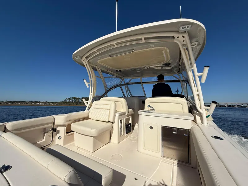 Slide: The Image of 2022 Grady-White Freedom 307 boat on water, featuring spacious seating and sleek design. - 41