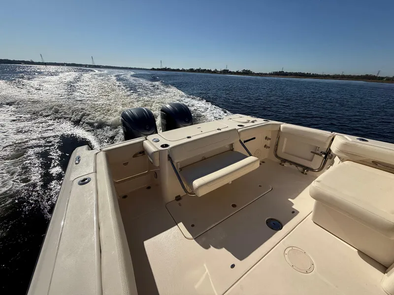 Slide: The Image of 2022 Grady-White Freedom 307 boat cruising on open water, rear view. - 45