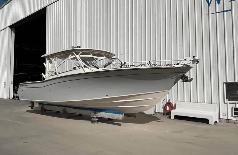 Slide: The Image of 2022 Grady-White Freedom 307 boat outside a large white warehouse. - 49