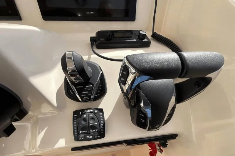 Slide: The Image of Control panel of 2022 Grady-White Freedom 307 boat with throttle and joystick. - 52